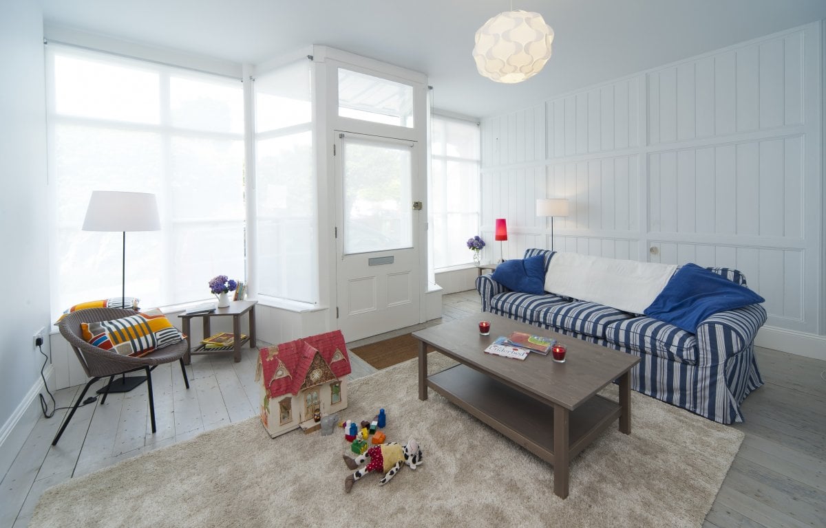 Buttery front room with piano, two sofas and other seating, former Victorian shopfront glazed to full width. Flatscreen TV/DVD/Chromecast, Hifi